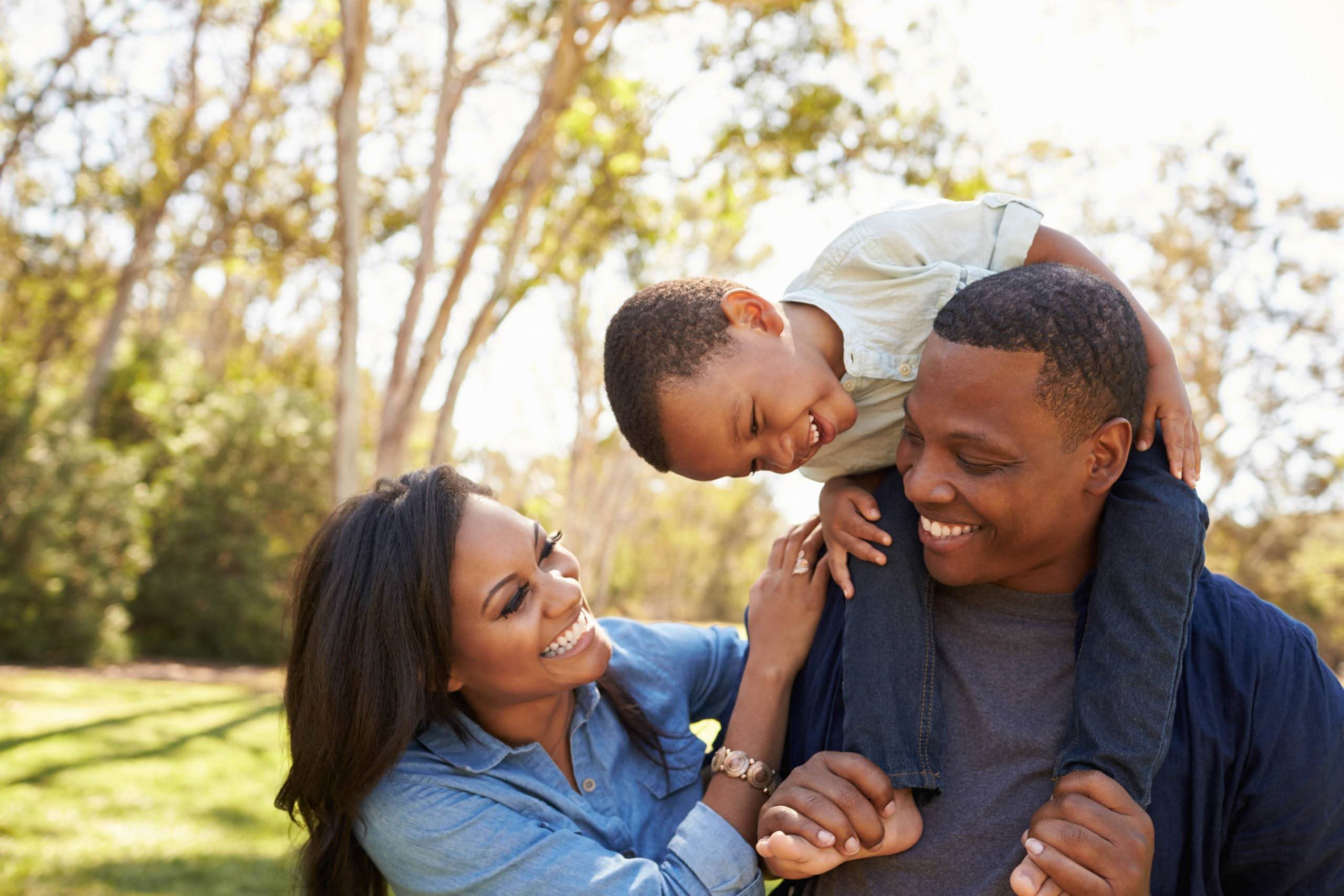 A family of three enjoying a sunny day outdoors at The Bristol Apartments, Greenville, SC